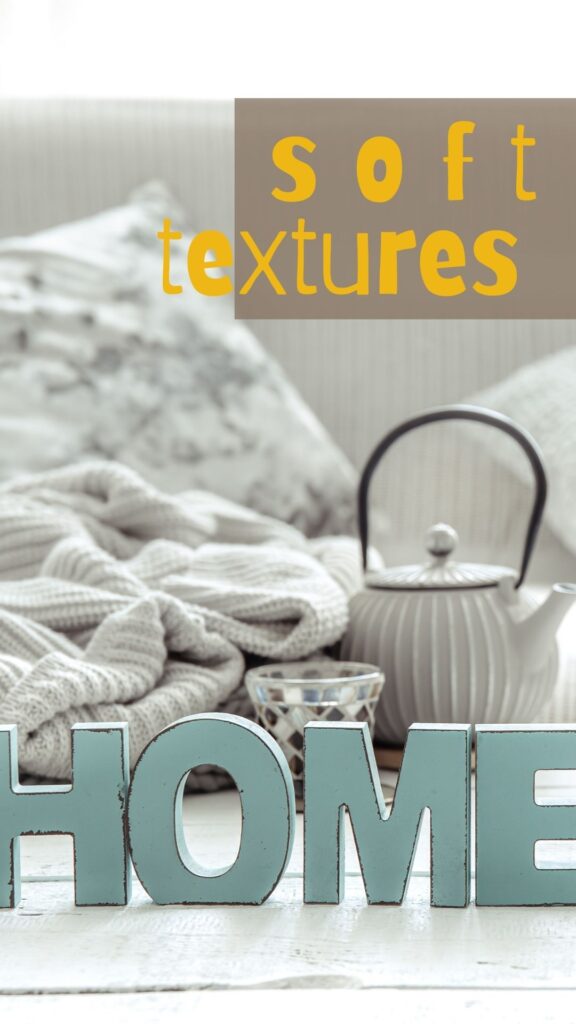 soft textures like woven blankets, velvet pillow and knitted throws make a space feel cozy