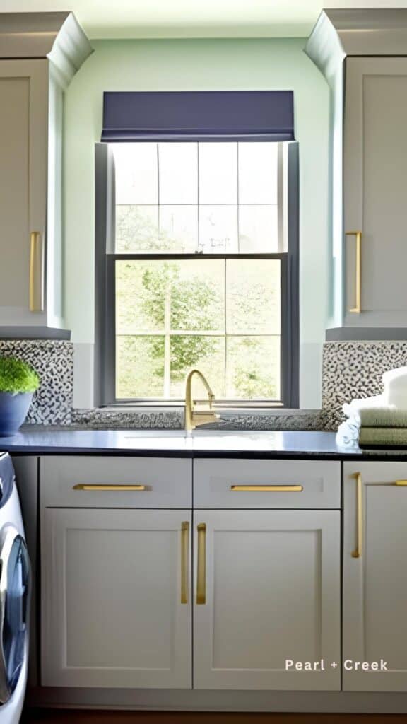 Green walls with tiled surround, gray lower cabinets and upper cabinets and wood floors. 