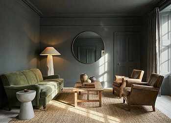 Elegant living room with vintage furniture and soft natural lighting color drenched in matt gray.